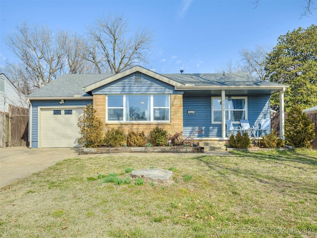 view of front of property with covered porch, fence, a garage, driveway, and a front lawn