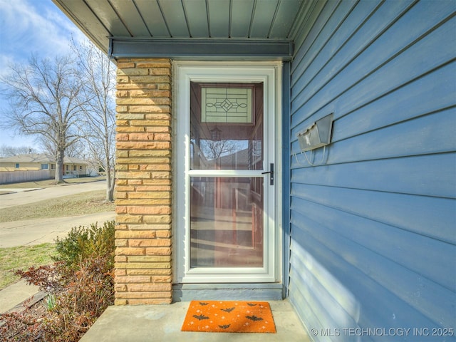 doorway to property featuring board and batten siding and stone siding