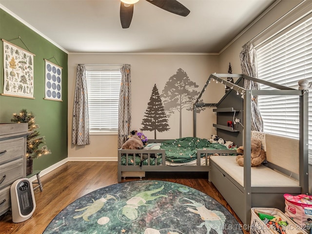 bedroom with multiple windows, crown molding, and wood finished floors