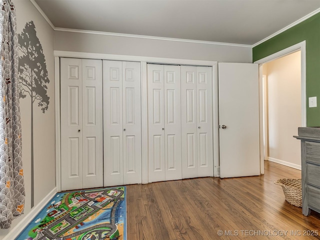 interior space with ornamental molding and wood finished floors