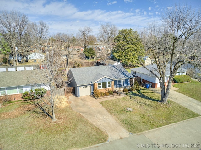 ranch-style house with a garage, concrete driveway, and a front yard