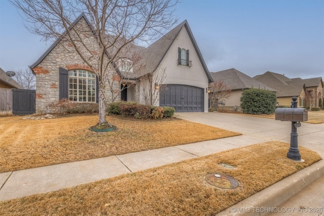 view of front of property with stucco siding, concrete driveway, a garage, stone siding, and a front lawn