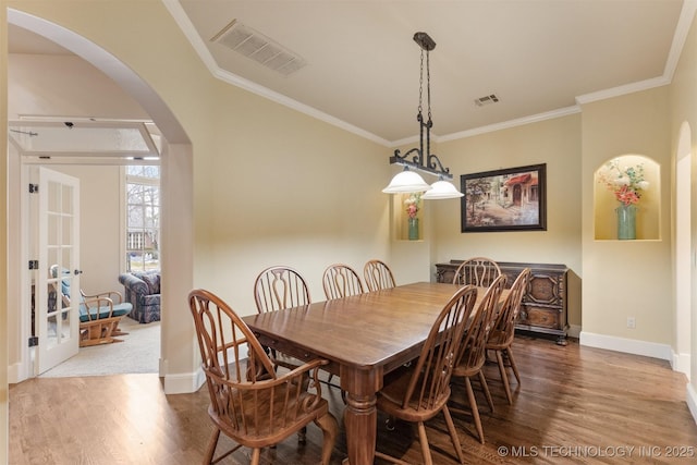 11870 S Oswego Ave, Tulsa, OK 74137 - dining room with arched walkways, wood finished floors, baseboards, and crown molding
