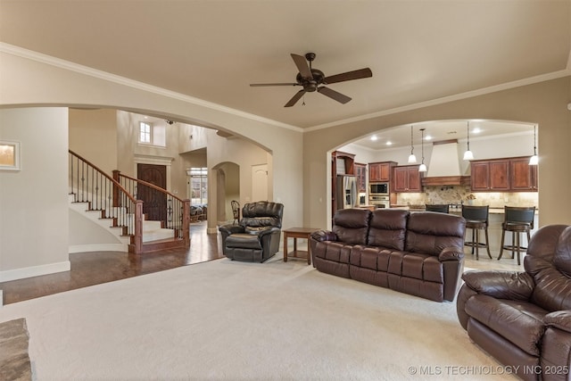 11870 S Oswego Ave, Tulsa, OK 74137 - living area with ornamental molding, ceiling fan, baseboards, stairs, and arched walkways