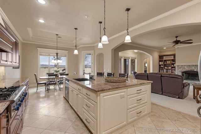 11870 S Oswego Ave, Tulsa, OK 74137 - kitchen with a sink, arched walkways, light tile patterned floors, stainless steel appliances, and a tray ceiling