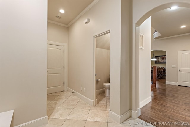 11870 S Oswego Ave, Tulsa, OK 74137 - hallway with arched walkways, ornamental molding, baseboards, recessed lighting, and light tile patterned flooring