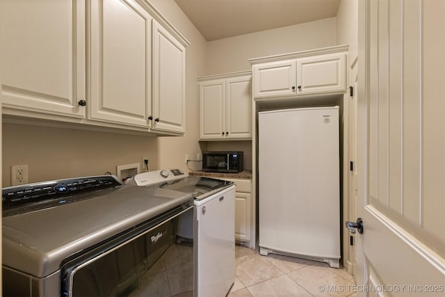 11870 S Oswego Ave, Tulsa, OK 74137 - washroom featuring cabinet space, separate washer and dryer, and light tile patterned floors