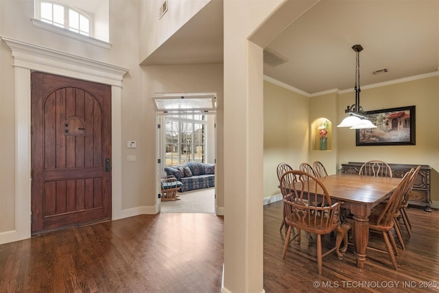 11870 S Oswego Ave, Tulsa, OK 74137 - dining area with wood finished floors, healthy amount of natural light, baseboards, ornamental molding, and arched walkways
