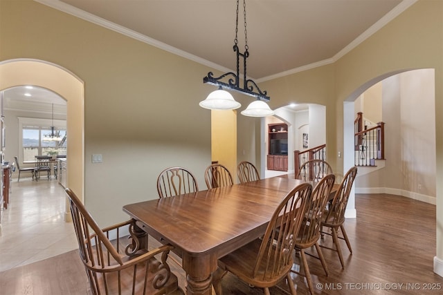 11870 S Oswego Ave, Tulsa, OK 74137 - dining space with arched walkways, ornamental molding, stairway, baseboards, and light wood-style floors