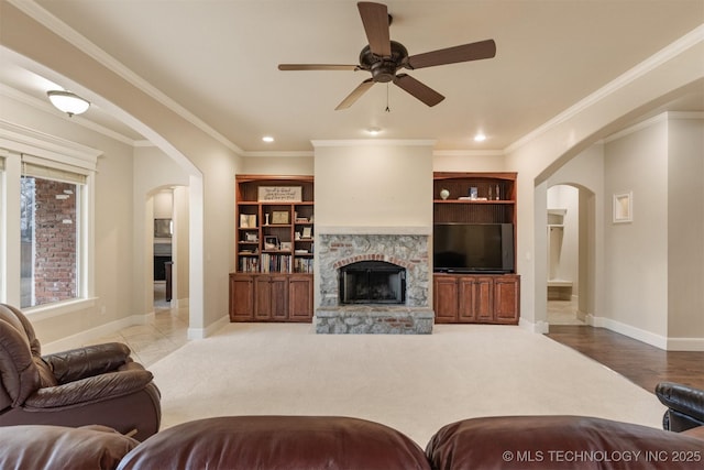 11870 S Oswego Ave, Tulsa, OK 74137 - living area featuring arched walkways, baseboards, a ceiling fan, a fireplace, and recessed lighting