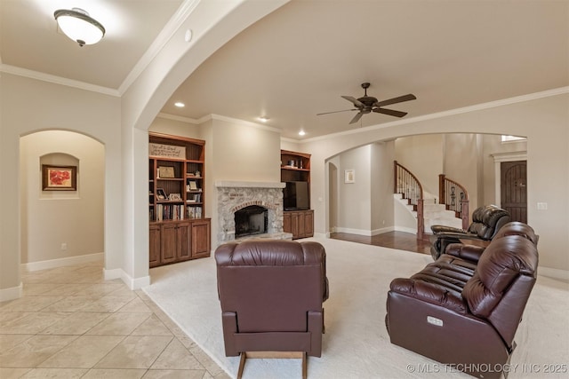 11870 S Oswego Ave, Tulsa, OK 74137 - living area with arched walkways, baseboards, built in shelves, ceiling fan, and ornamental molding