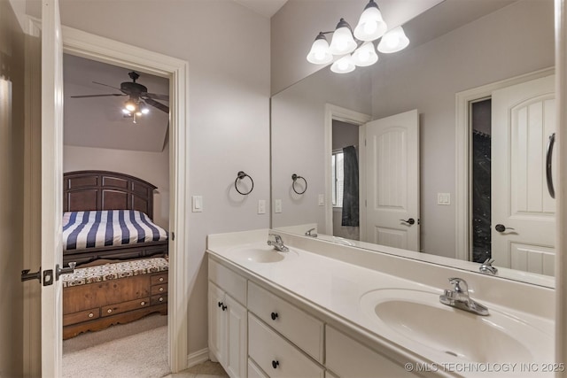 11870 S Oswego Ave, Tulsa, OK 74137 - bathroom with connected bathroom, double vanity, ceiling fan, baseboards, and a chandelier