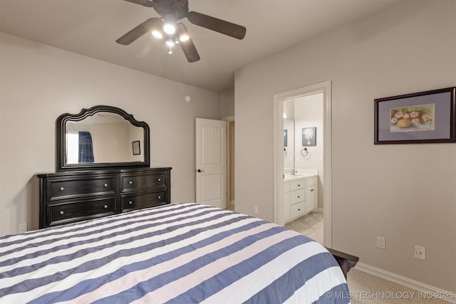 11870 S Oswego Ave, Tulsa, OK 74137 - bedroom featuring ensuite bath, baseboards, a ceiling fan, a sink, and carpet floors