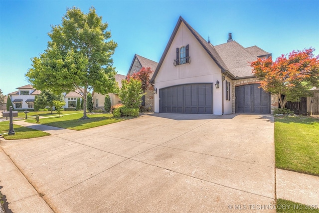 11870 S Oswego Ave, Tulsa, OK 74137 - french country home with concrete driveway, a front lawn, a shingled roof, stone siding, and stucco siding