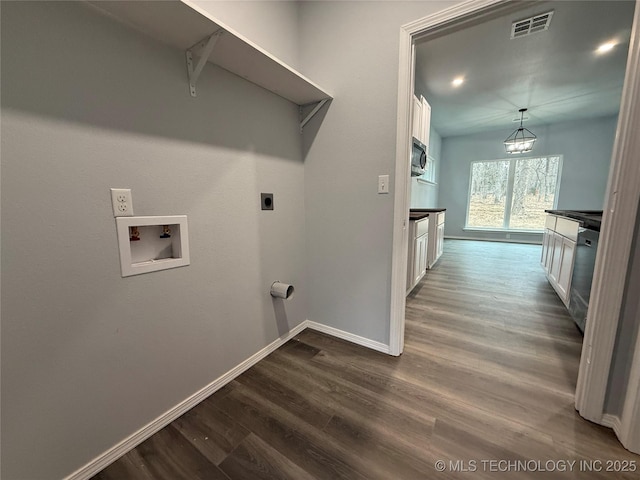 washroom with laundry area, visible vents, dark wood-style floors, hookup for a washing machine, and hookup for an electric dryer