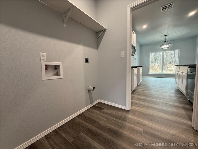 washroom featuring washer hookup, visible vents, dark wood-type flooring, hookup for an electric dryer, and laundry area