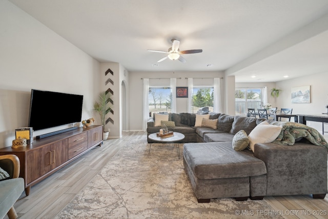 living area with wood finish floors and a ceiling fan