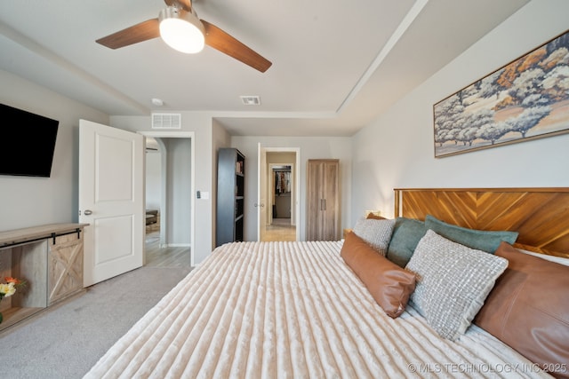 bedroom featuring ceiling fan, light carpet, and visible vents