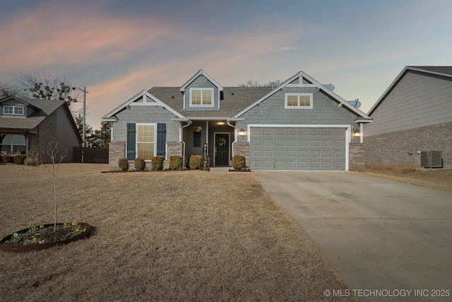 view of front of home featuring a garage, central AC, fence, and concrete driveway