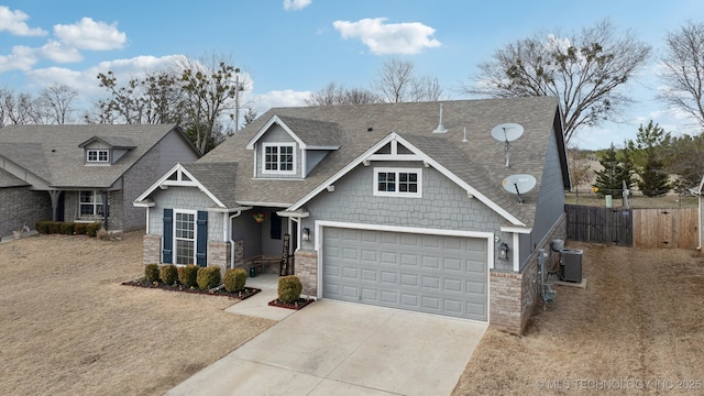 craftsman-style house featuring a garage, concrete driveway, roof with shingles, fence, and cooling unit