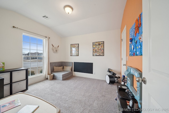 sitting room with lofted ceiling, carpet, visible vents, and baseboards