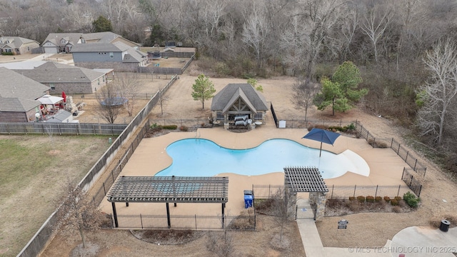 community pool featuring a fenced backyard and a patio