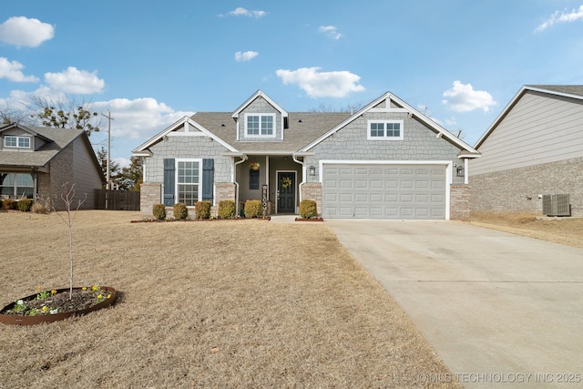 view of front of property with central air condition unit, an attached garage, fence, and concrete driveway