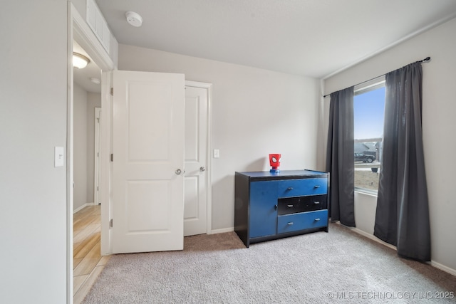 bedroom with carpet and baseboards