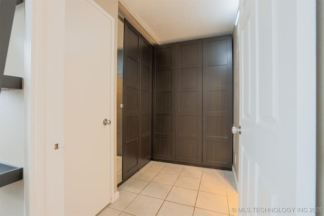 bathroom with tile patterned flooring and a textured ceiling