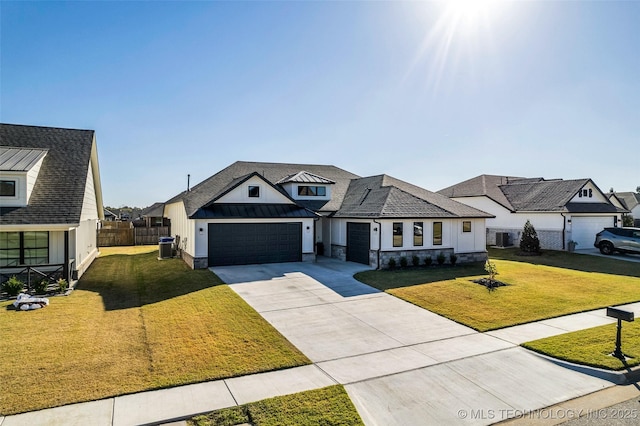 modern farmhouse with driveway, metal roof, a standing seam roof, fence, and a front yard