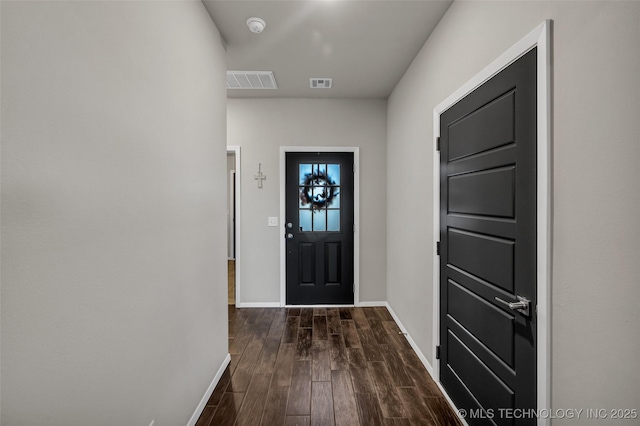 entryway with dark wood-type flooring, visible vents, and baseboards