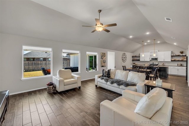 living area with baseboards, visible vents, lofted ceiling, ceiling fan, and dark wood-type flooring