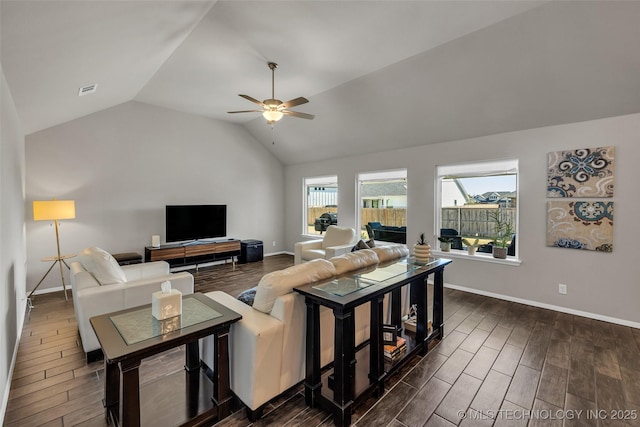 living area with wood finish floors, lofted ceiling, visible vents, a ceiling fan, and baseboards