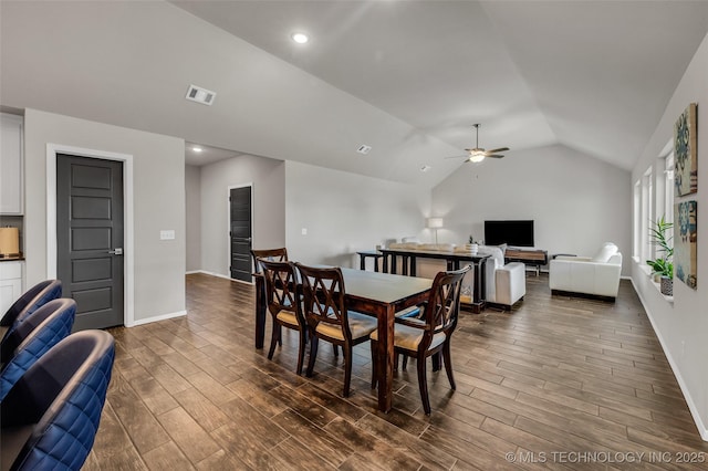 dining area featuring lofted ceiling, baseboards, visible vents, and dark wood-style flooring