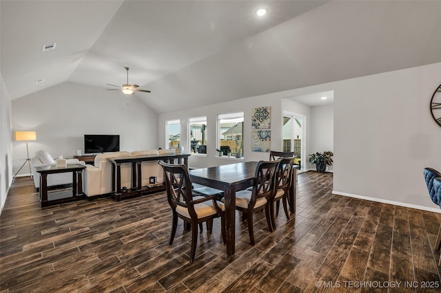 dining room featuring lofted ceiling, wood tiled floor, baseboards, and ceiling fan