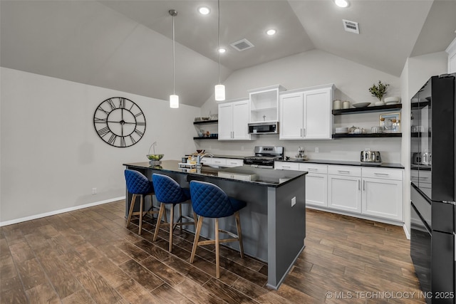 kitchen featuring dark wood-style floors, stainless steel appliances, visible vents, and open shelves