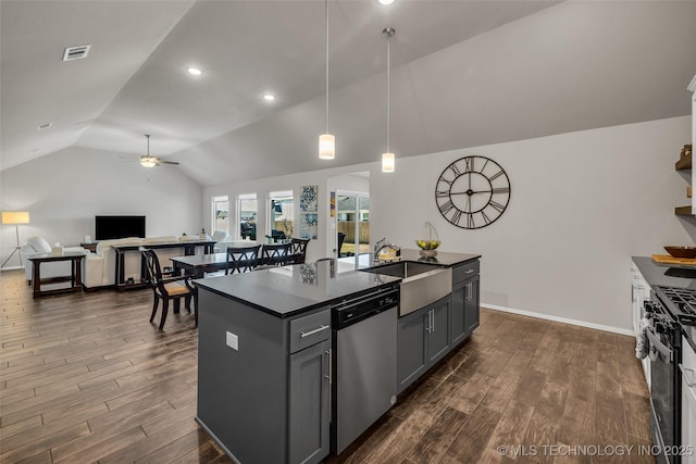 kitchen featuring dark countertops, visible vents, black gas range oven, stainless steel dishwasher, and dark wood-type flooring