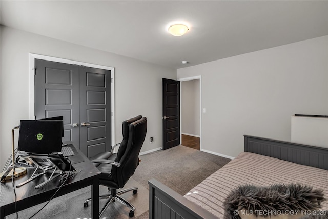 carpeted bedroom featuring a closet and baseboards