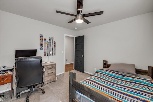 bedroom with baseboards, a ceiling fan, and light colored carpet