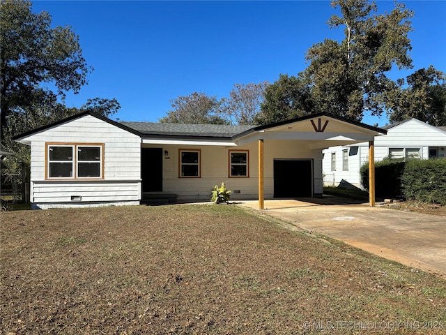 single story home with an attached carport, a shingled roof, driveway, crawl space, and a front lawn