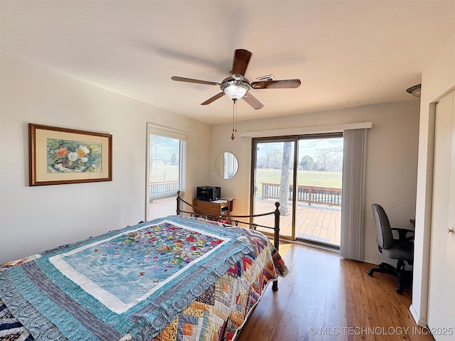 bedroom featuring ceiling fan, access to outside, multiple windows, and light wood-style flooring