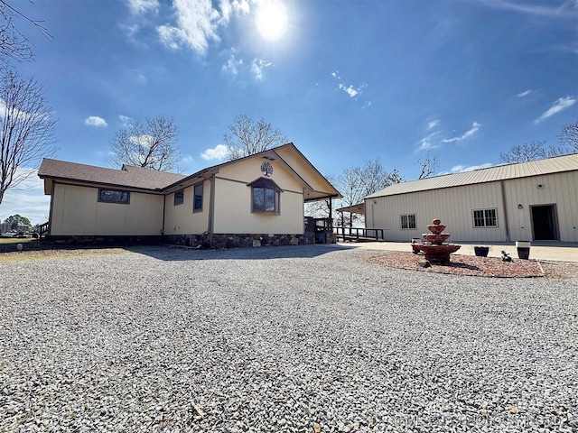 rear view of house featuring driveway