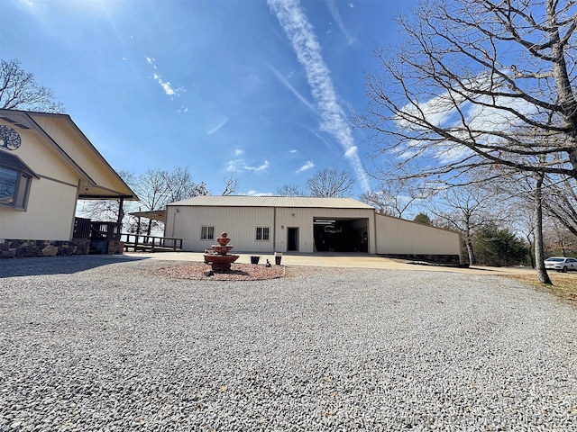 view of front of house with an outdoor structure and a detached garage