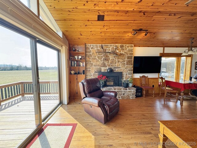 32432 S Skyline Dr, Cookson, OK 74427 - living area featuring vaulted ceiling, wooden ceiling, light wood-style flooring, and a stone fireplace