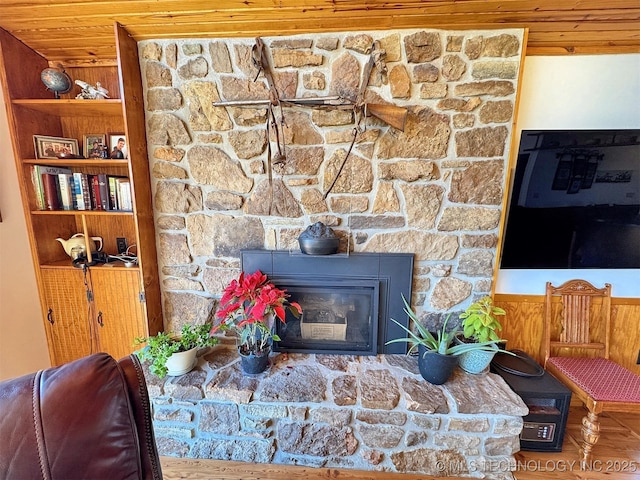 living area featuring wooden ceiling and a fireplace