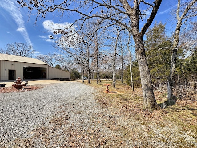 view of road featuring a pole building and driveway