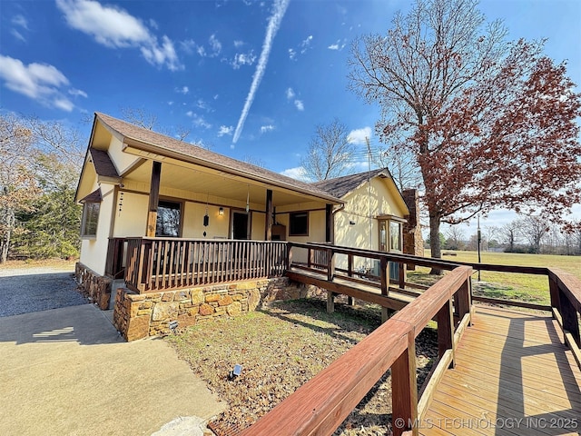 view of front facade with covered porch and a shingled roof