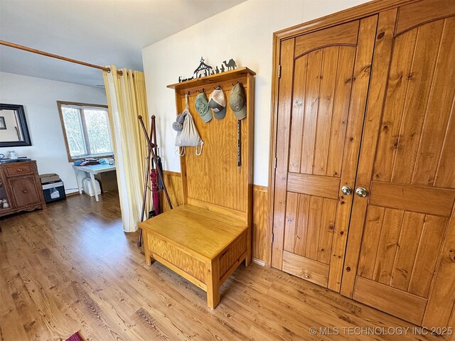 mudroom featuring light wood-style floors and wainscoting