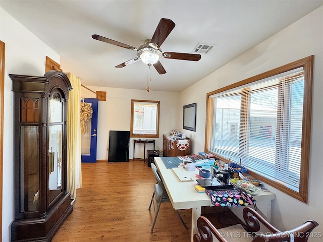 dining area with a ceiling fan, visible vents, and light wood-style floors