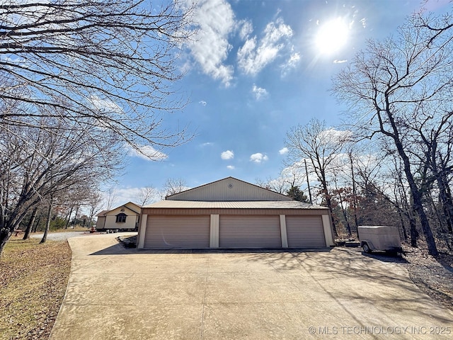 exterior space featuring a garage and an outdoor structure